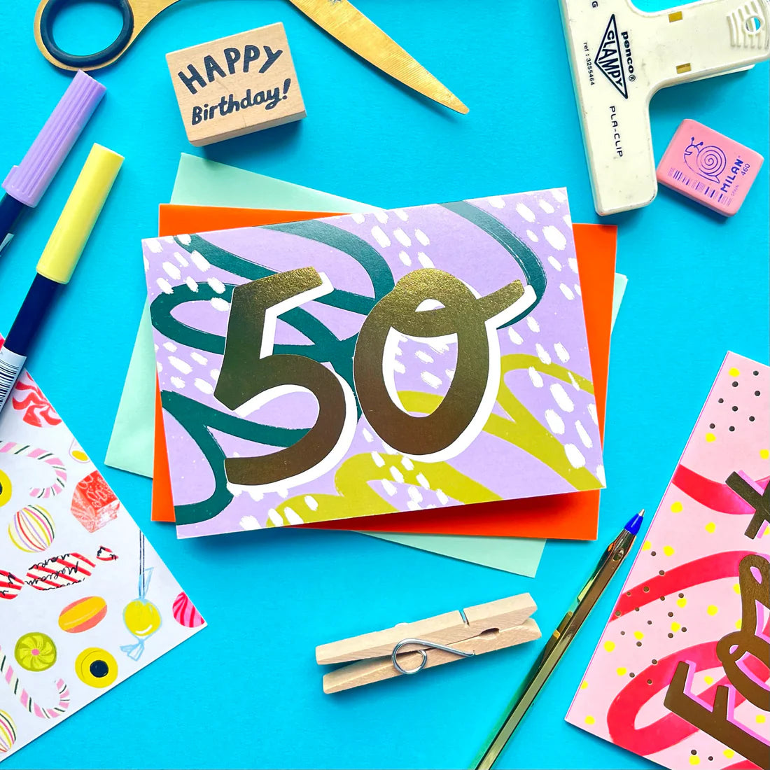 A6 card with "50" text and a green envelope