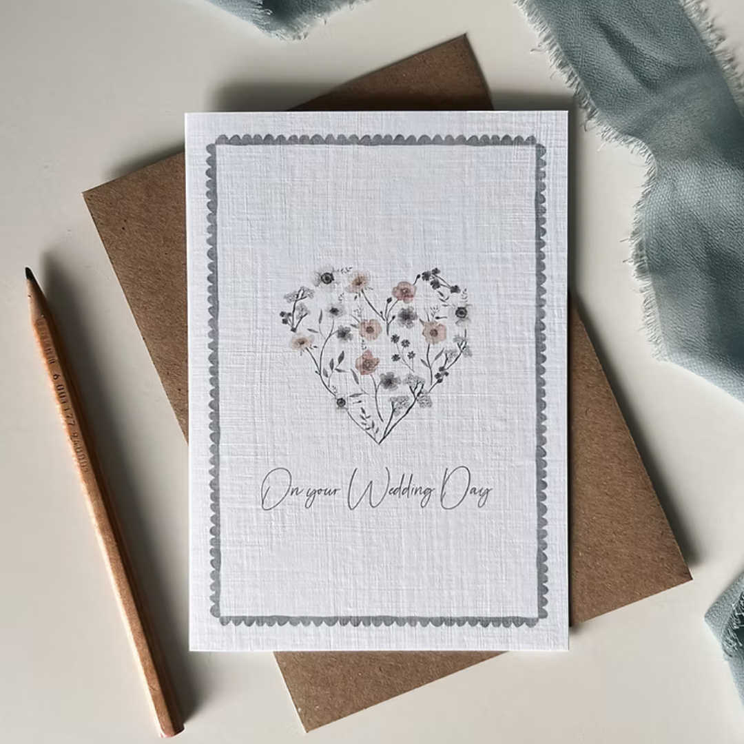 Greeting card with floral heart design and 'On your Wedding Day' text.