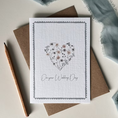 Greeting card with floral heart design and 'On your Wedding Day' text.