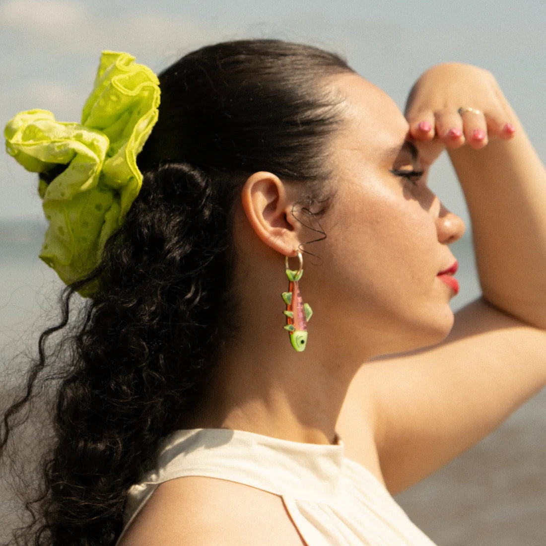 Rainbow trout pendants on gold painted stainless steel hoop earrings modelled