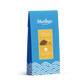 A blue stand-up pouch of Skelligs Chocolate Milk Chocolate Honeycomb Clusters, featuring a yellow label with an image of the chocolate clusters and blue wave patterns at the bottom, set against a plain white background.