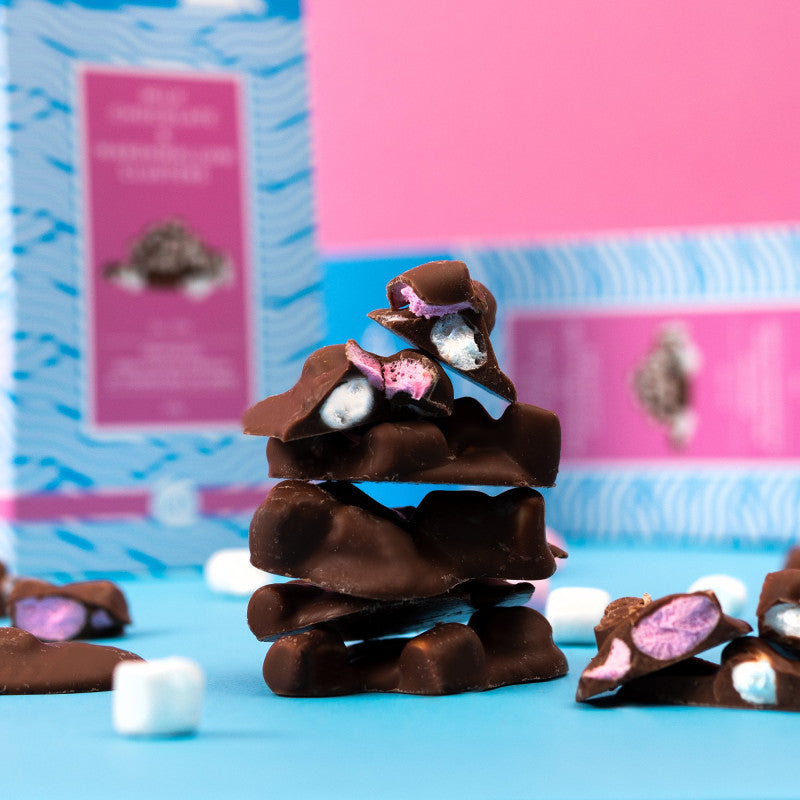 Stack of chocolate clusters with marshmallows on a blue background