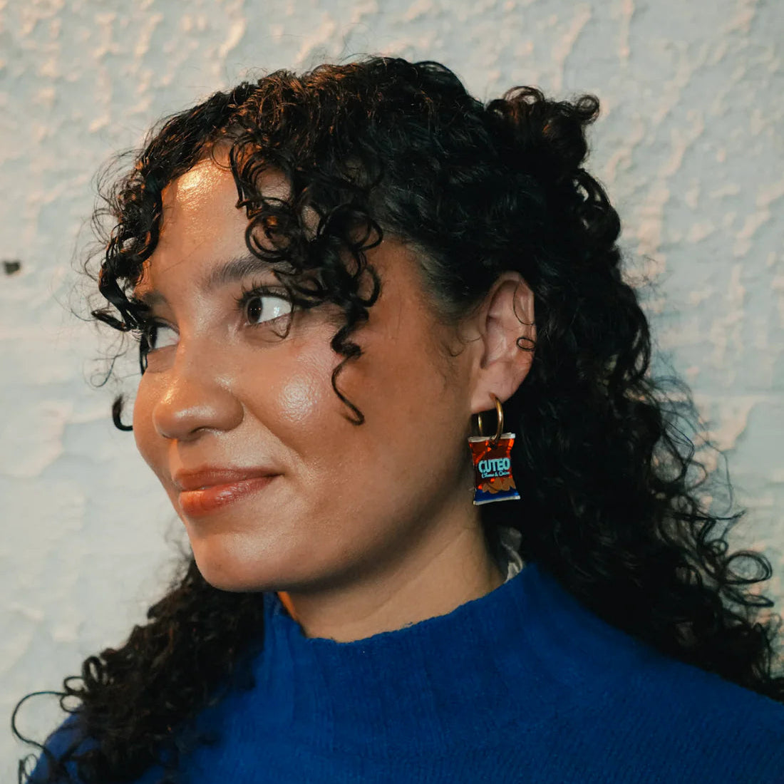 Southern & Northern crisp pendants on gold painted stainless steel hoop earrings modelled