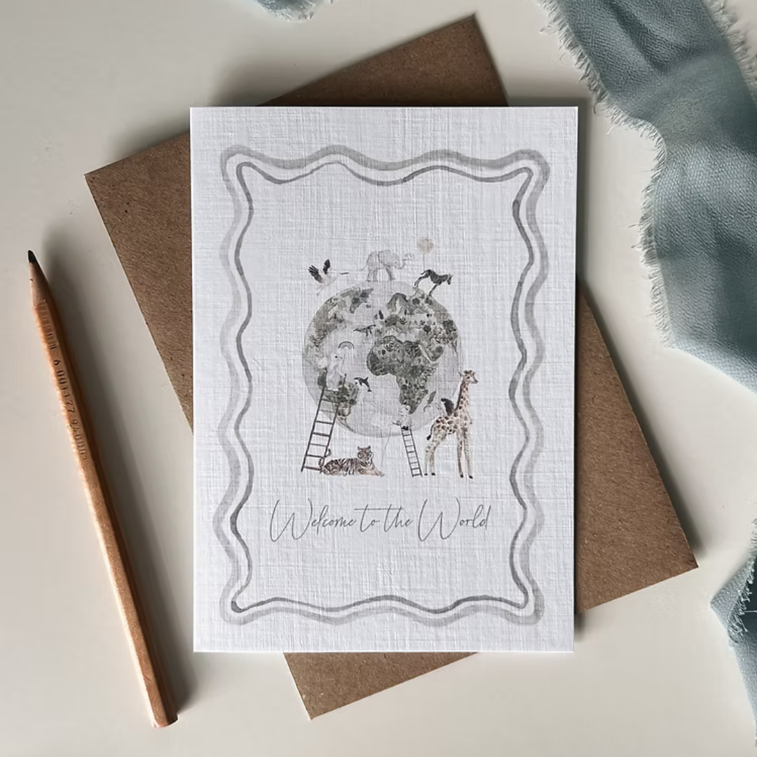 Greeting card with 'Welcome to the World' text and illustrations of animals around a  globe.