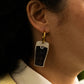  Split the G pendant on gold hoop earrings modelled