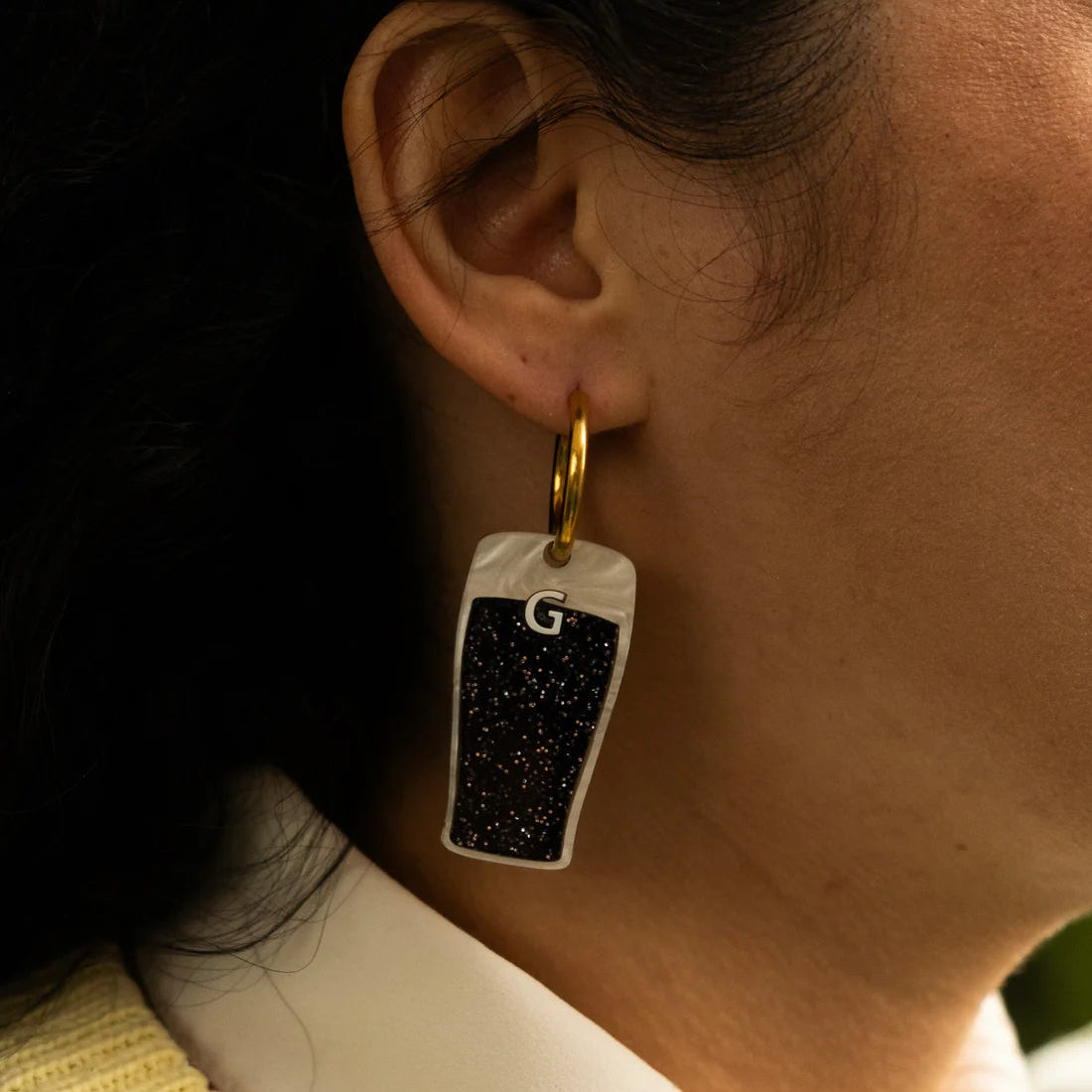  Split the G pendant on gold hoop earrings modelled